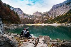 man sitting near lake