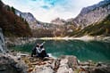 man sitting near lake 