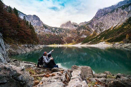 man sitting near lake 